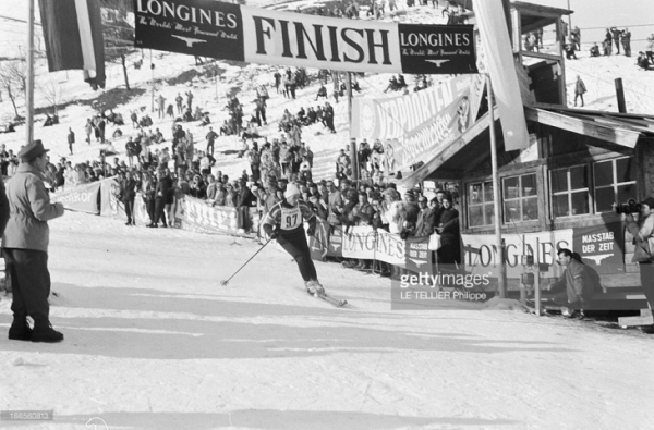 Karim Aga Khan, passing the finish line banner at a skiing competition at Davos 